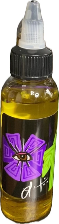 a bottle of liquid with a purple flower on it